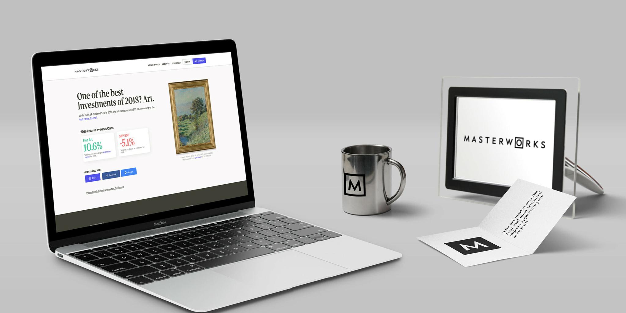Desk setup with laptop, mug, framed Masterworks logo, and branded card