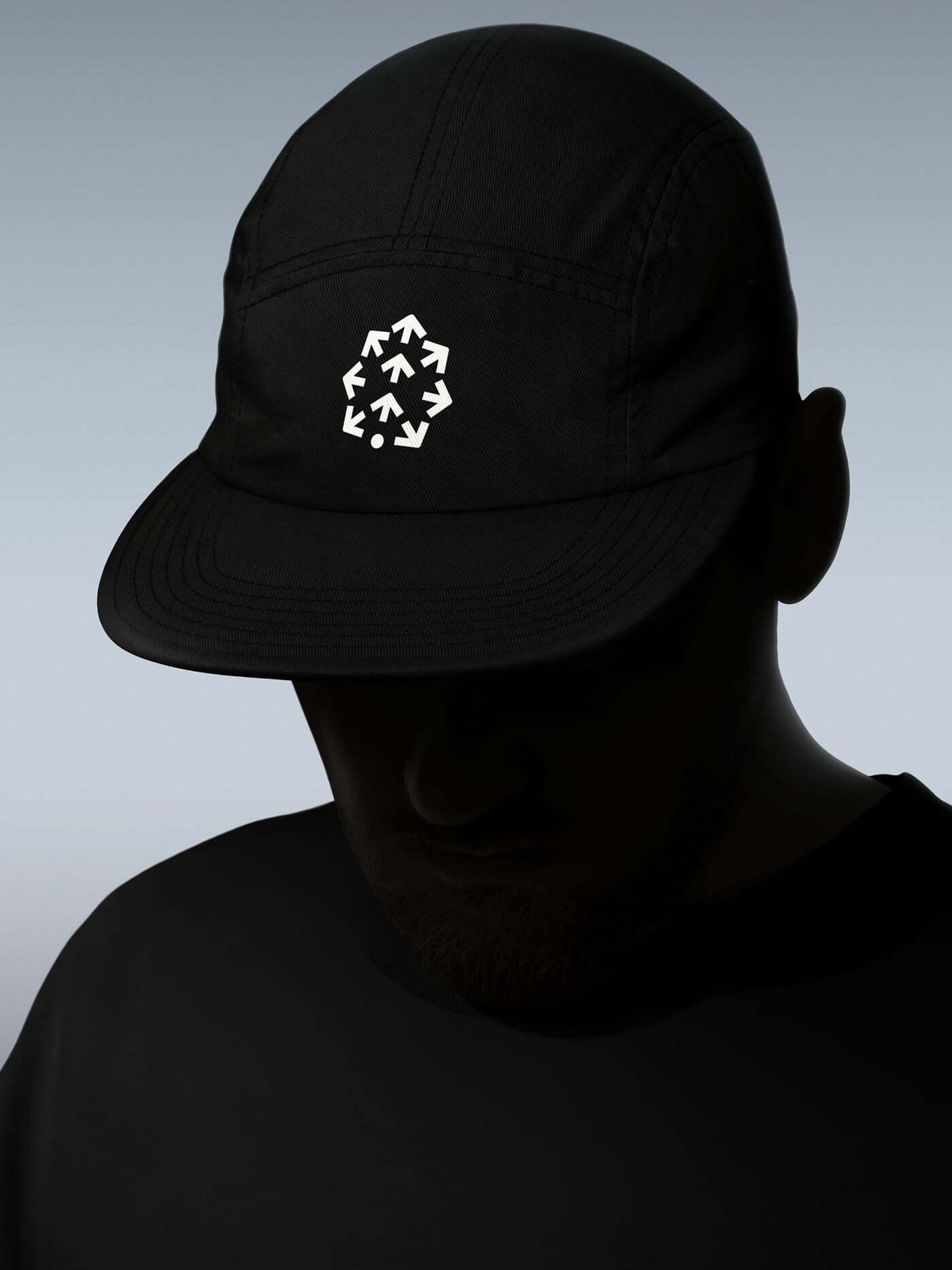 Person wearing a black cap with the Pinecone icon