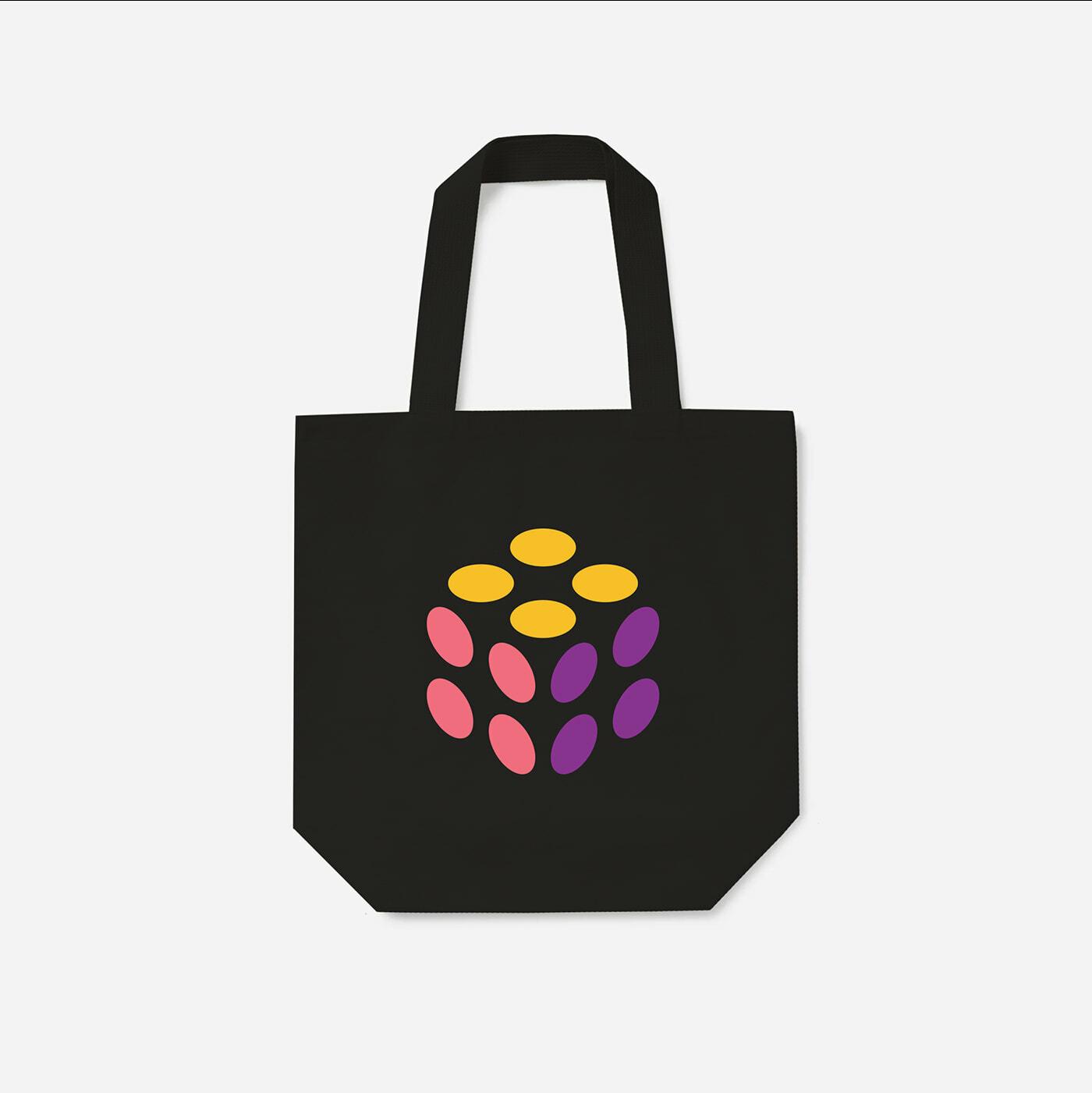 Black tote bag with a colorful Pulumi mark on a white background