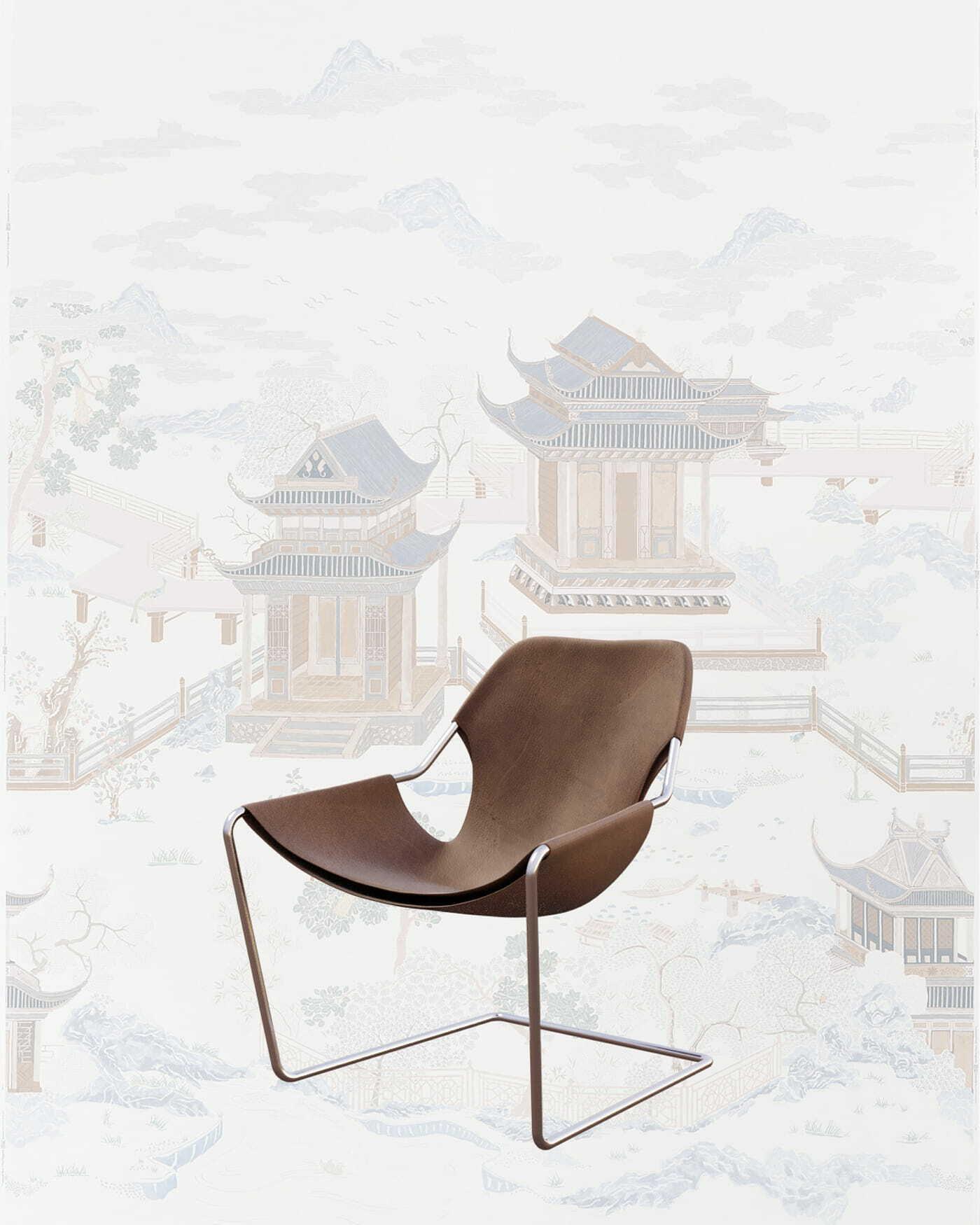 Brown sling lounge chair on a metal frame with pale Chinese landscape wallpaper behind