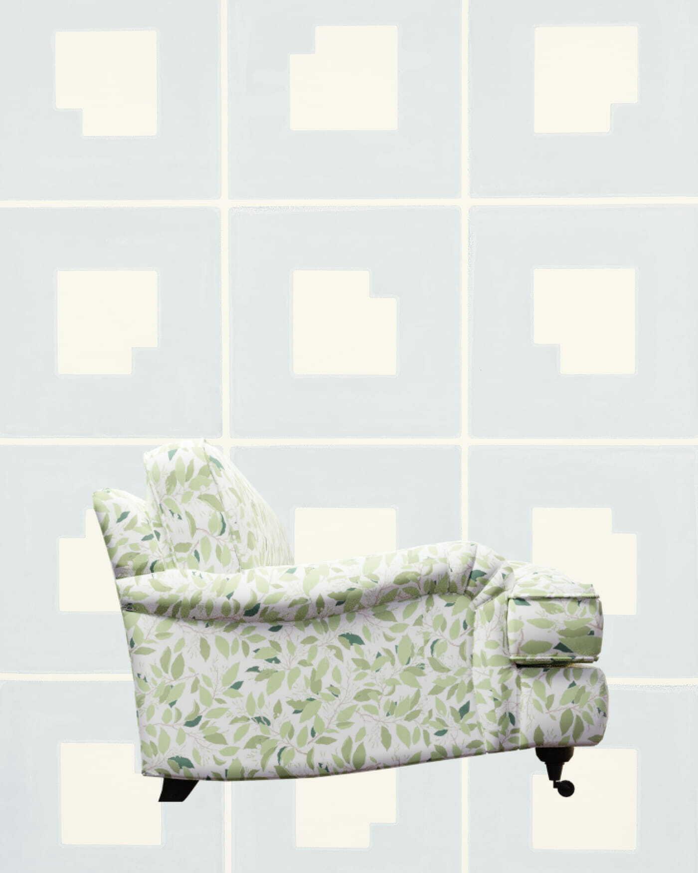 Green leaf-patterned sofa against a pale blue tiled wall