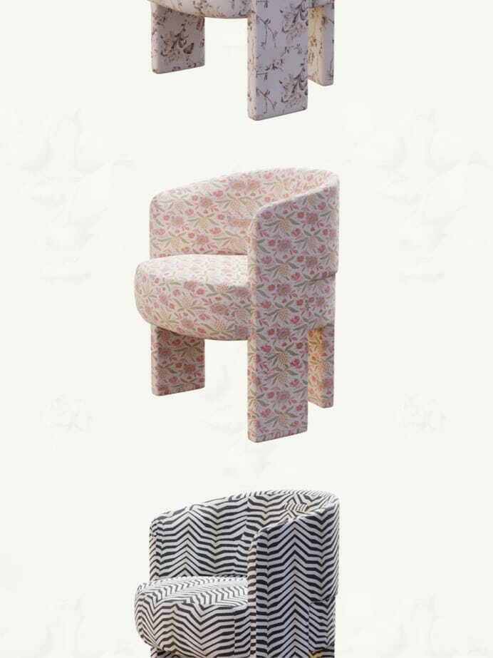 Three floating upholstered chairs with floral, speckled, and black-and-white zigzag fabrics