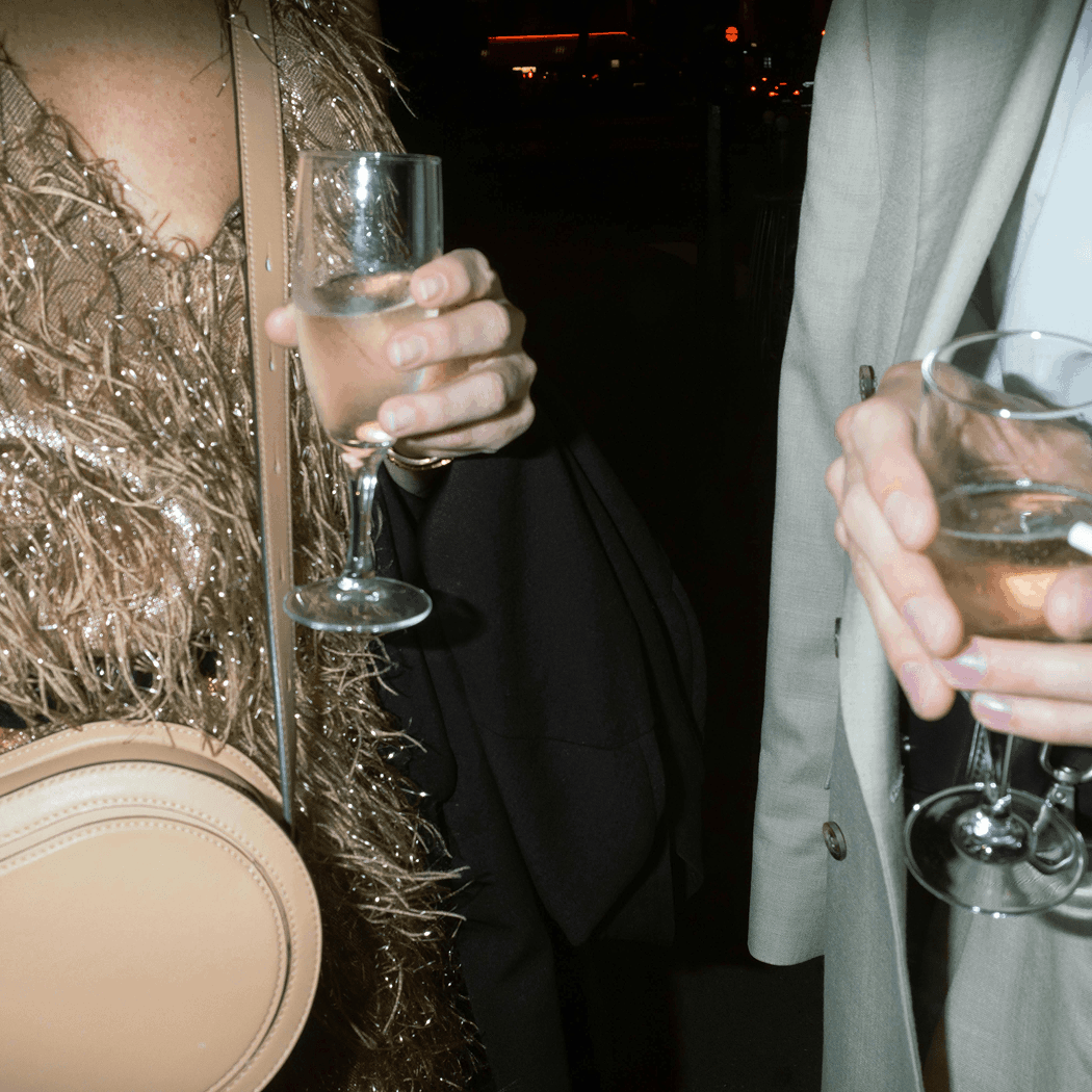 Close-up of two people holding champagne glasses at night