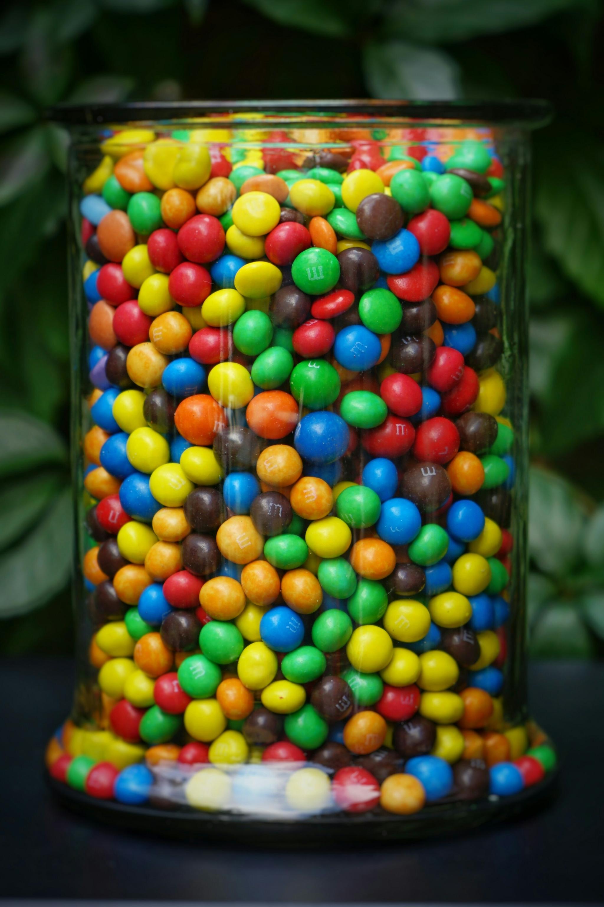 Glass jar filled with colorful candy-coated chocolates