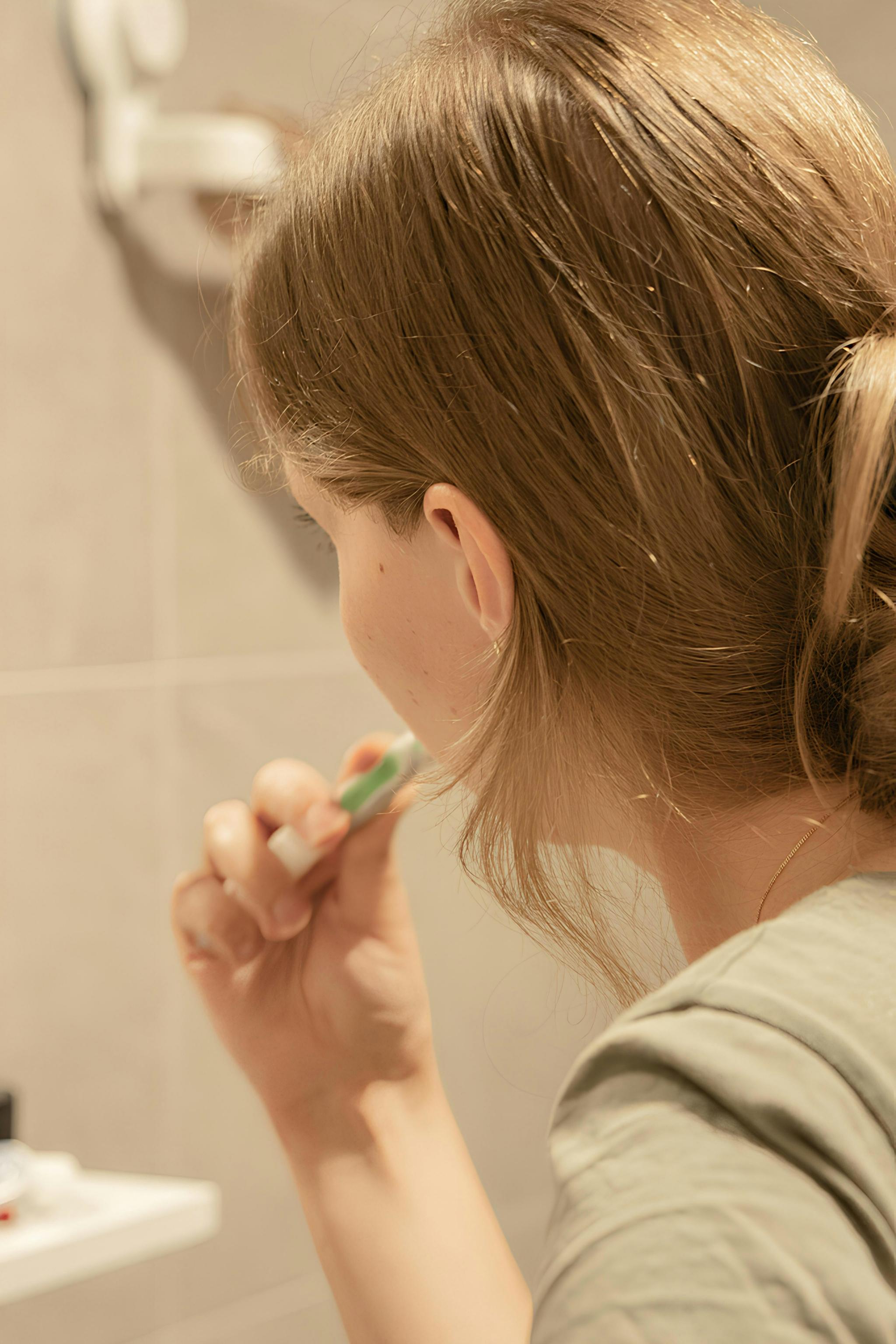 Child brushing teeth in a bathroom