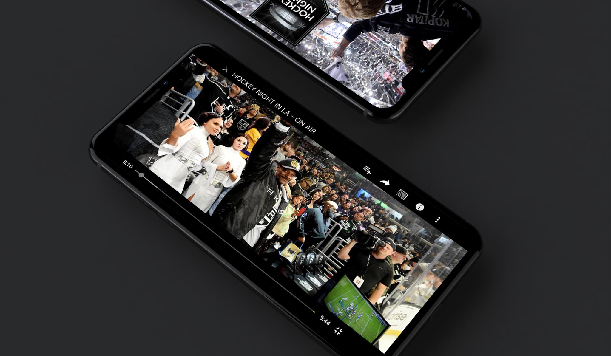 Phones playing Hockey Night in LA event videos on a dark surface