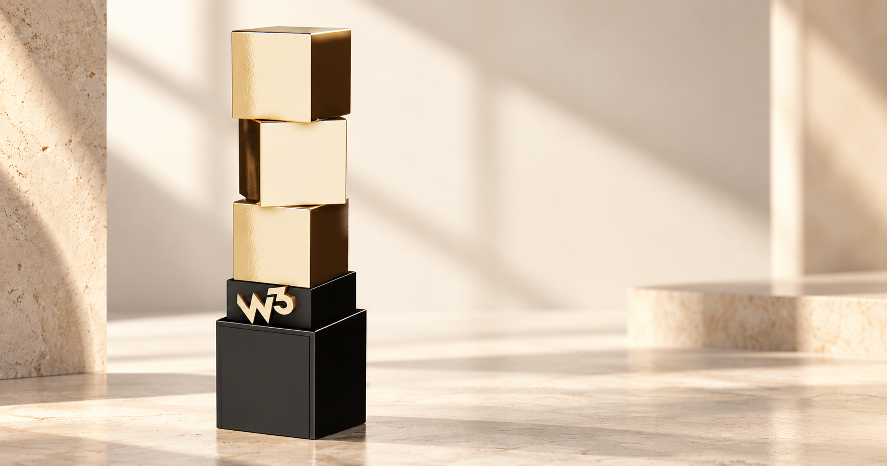 W3 Gold award statuette in a warm architectural studio setting.