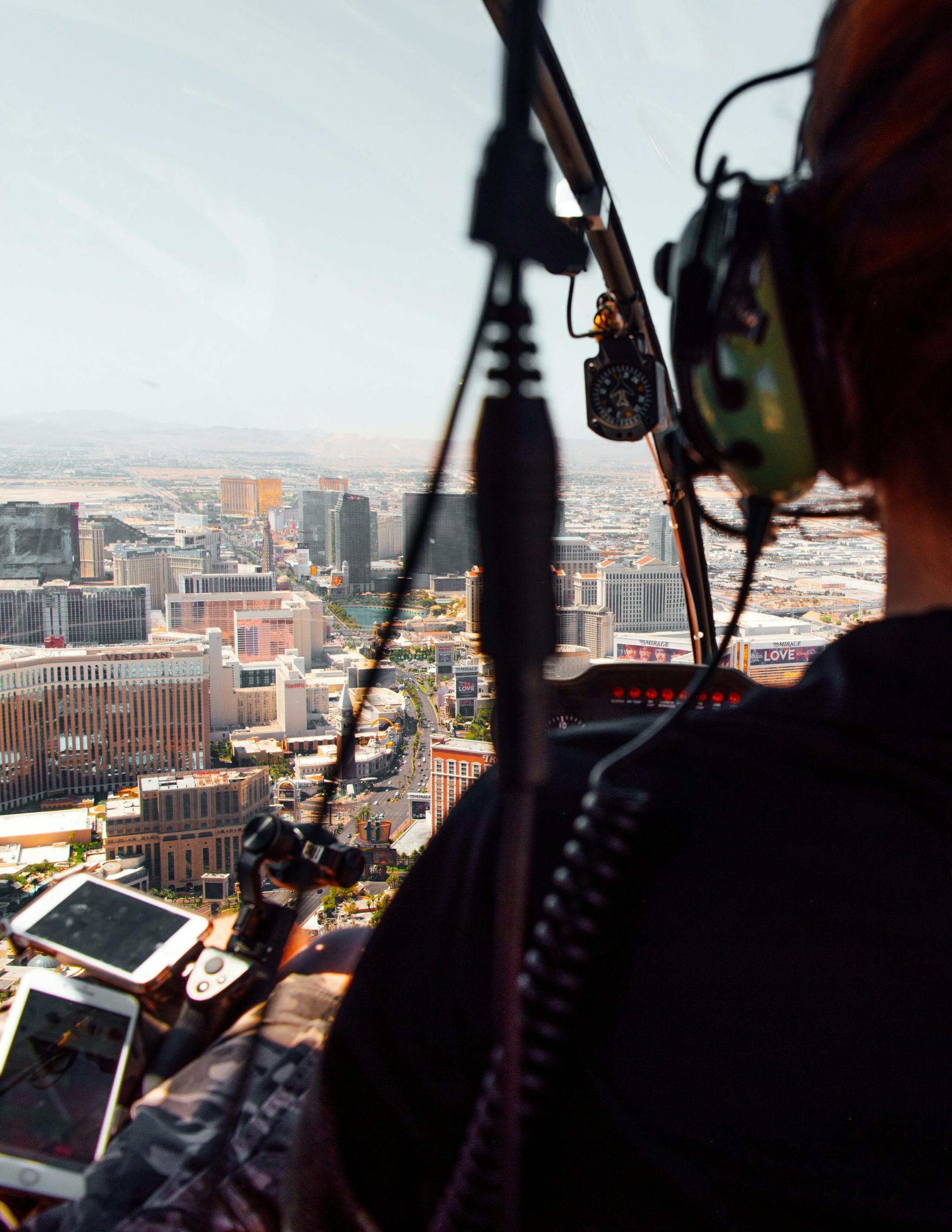 Helicopter passenger in a headset looking down over the Las Vegas Strip
