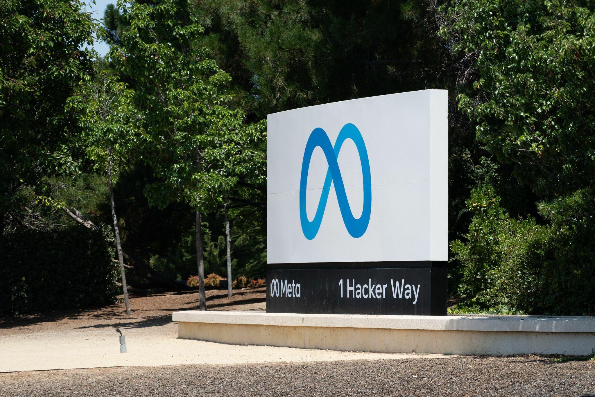 Meta headquarters entrance sign at 1 Hacker Way in Menlo Park.