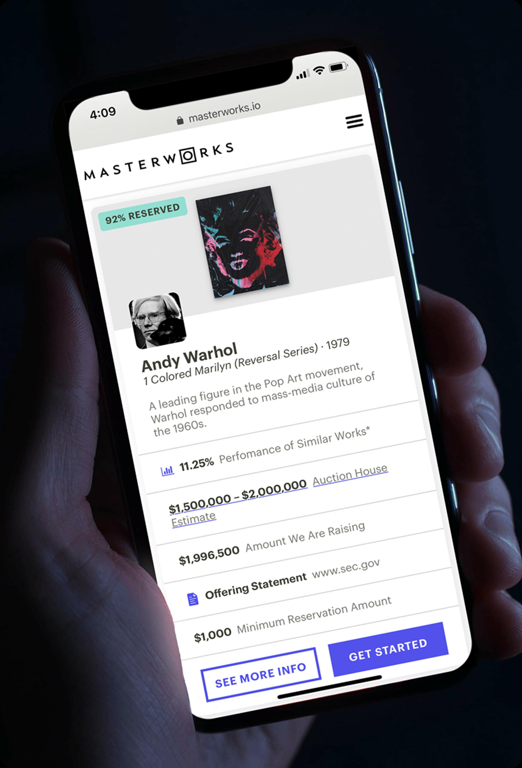 Hand holding a phone on the Masterworks Andy Warhol investment page
