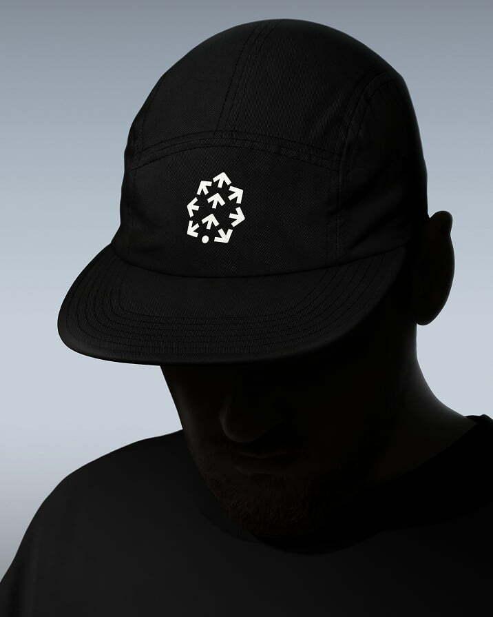 Person wearing a black cap with the Pinecone icon