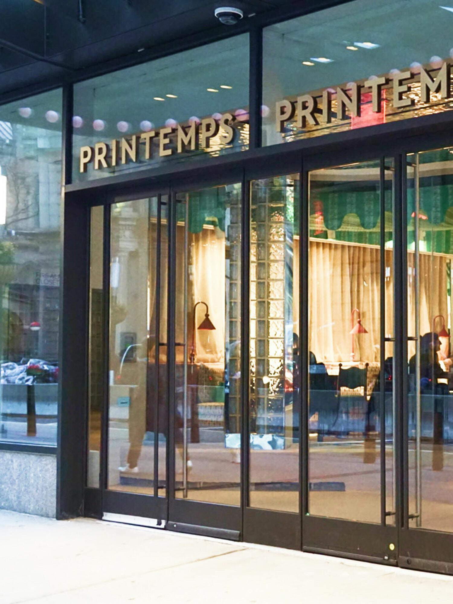 Printemps storefront entrance with glass doors and gold signage
