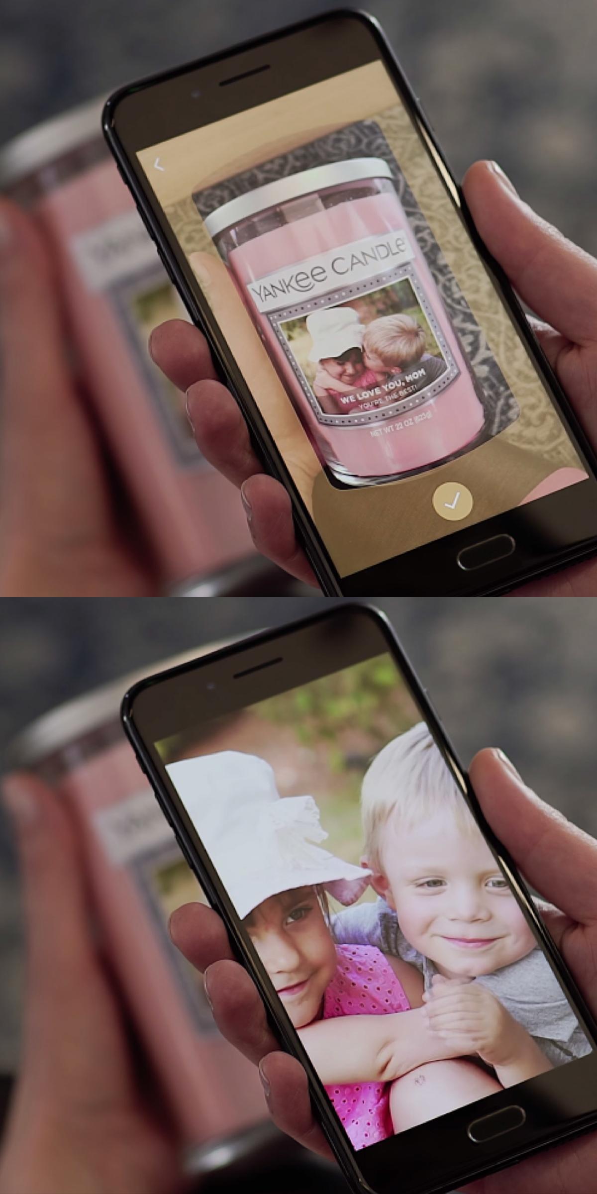 Phone showing a personalized Yankee Candle label above a full-screen child photo