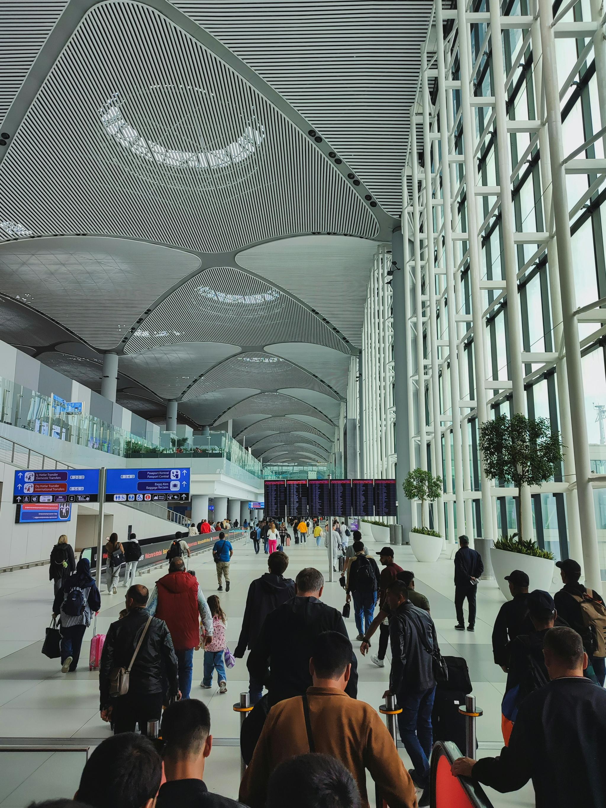 Crowded modern airport terminal with high arched ceilings