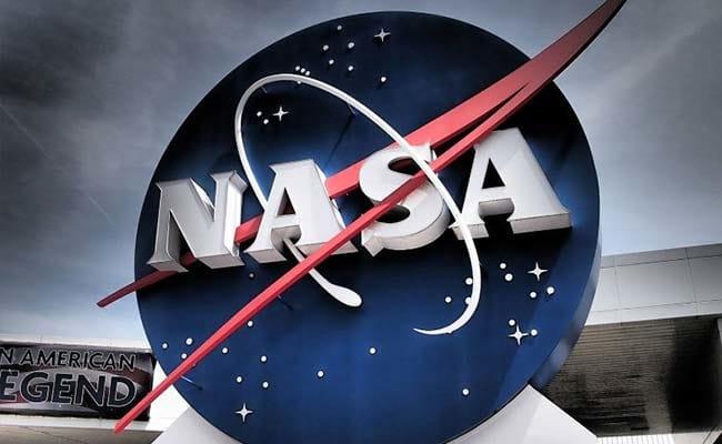 NASA logo sign outside a building under cloudy sky