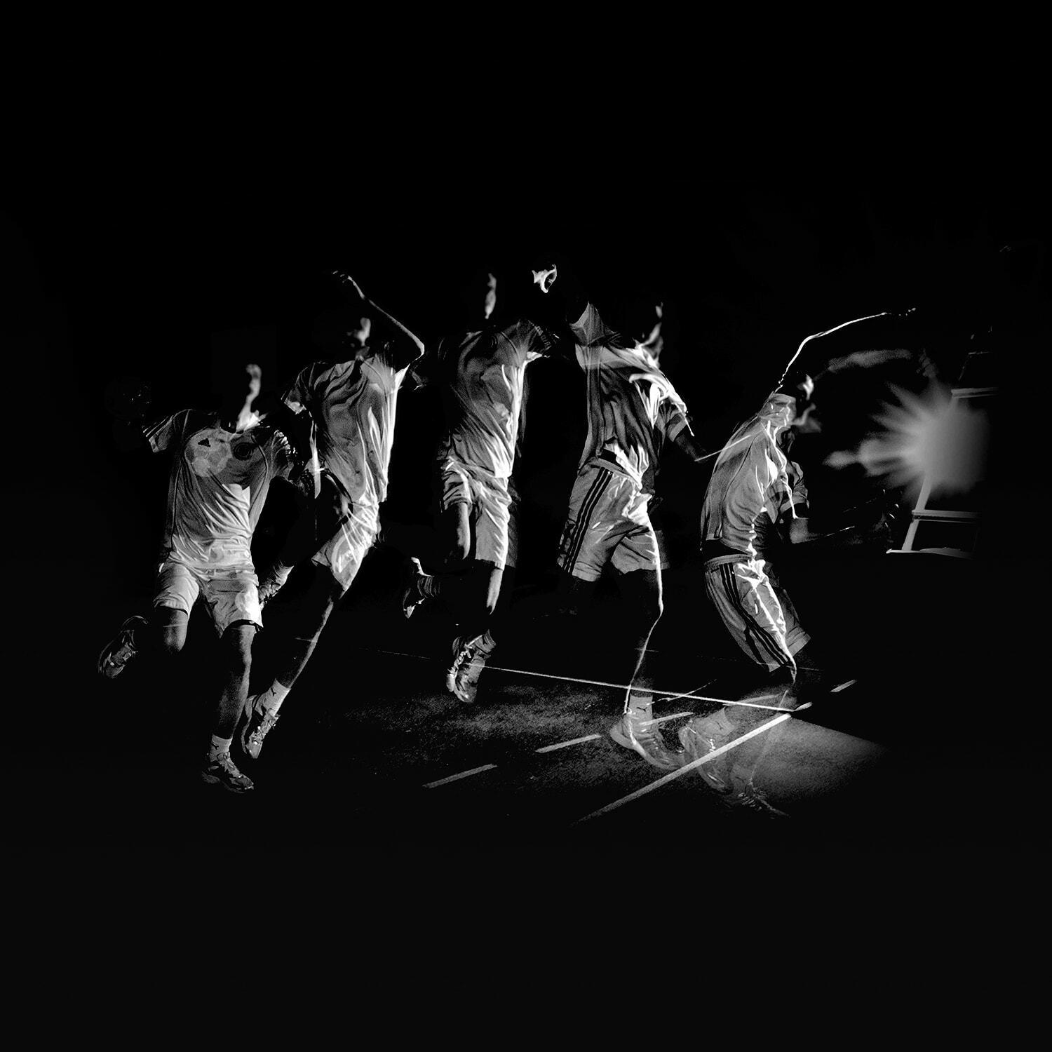 Black-and-white action shot of basketball players in motion