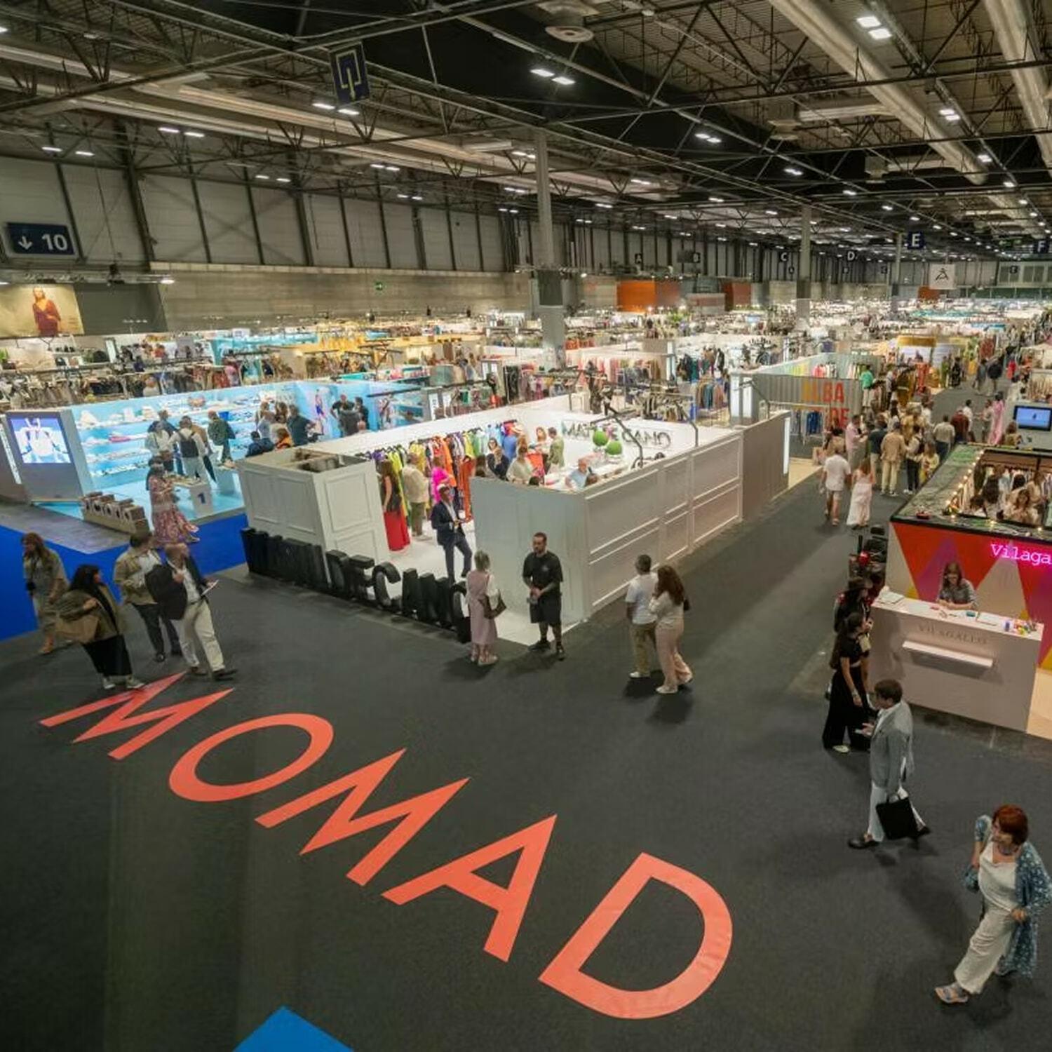 Large MOMAD trade show floor with booths and visitors
