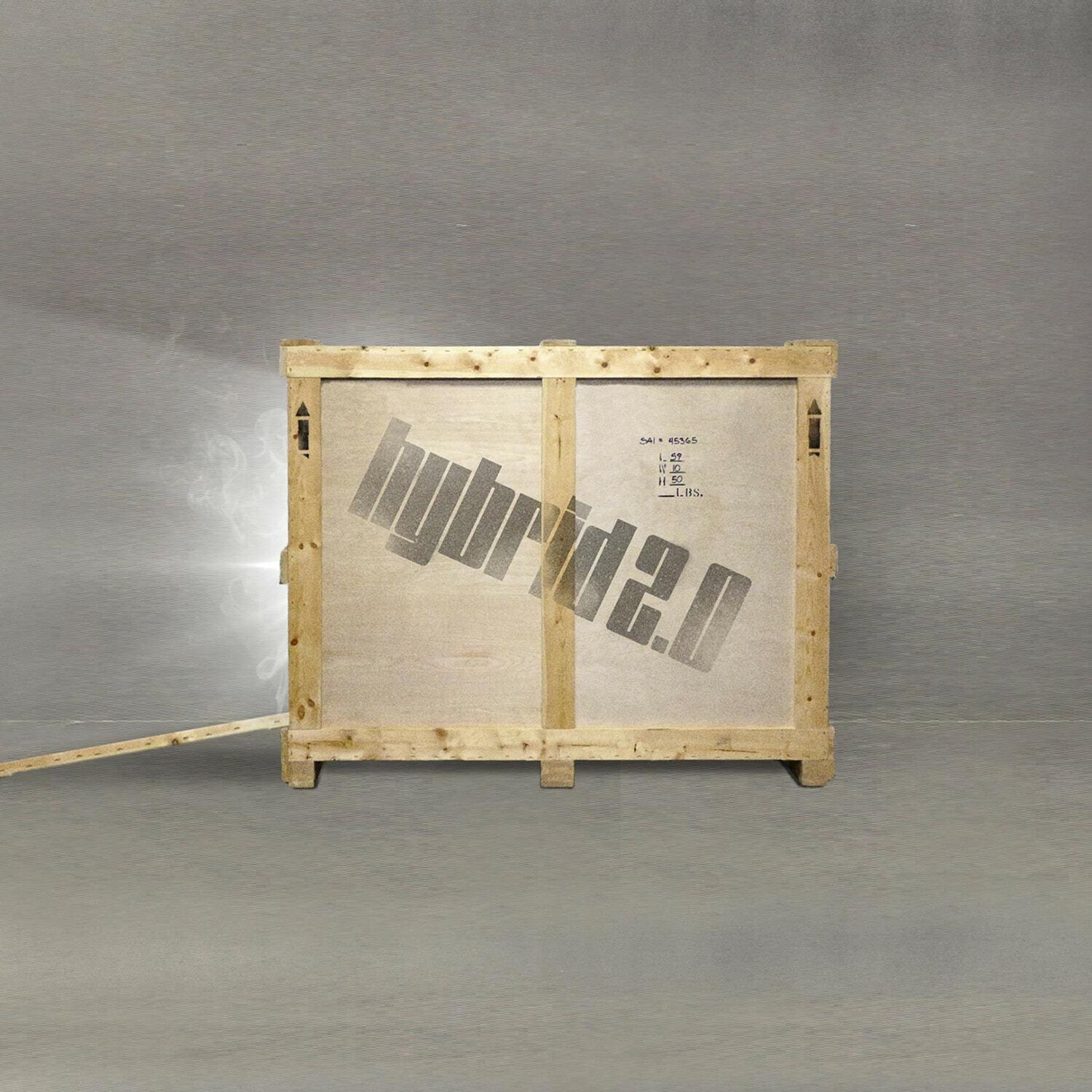Wooden shipping crate with a large stenciled logo on a gray floor