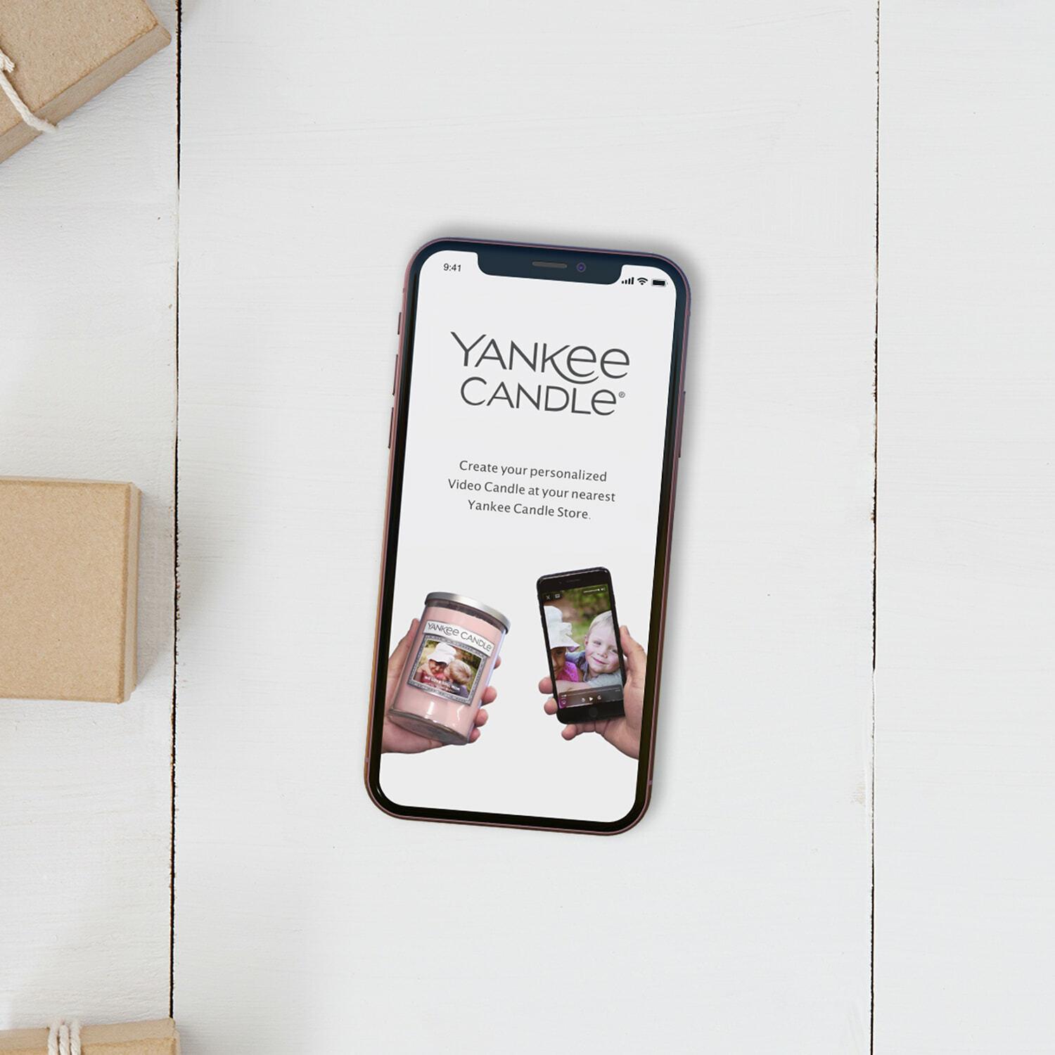 Phone displaying a Yankee Candle personalized video candle page