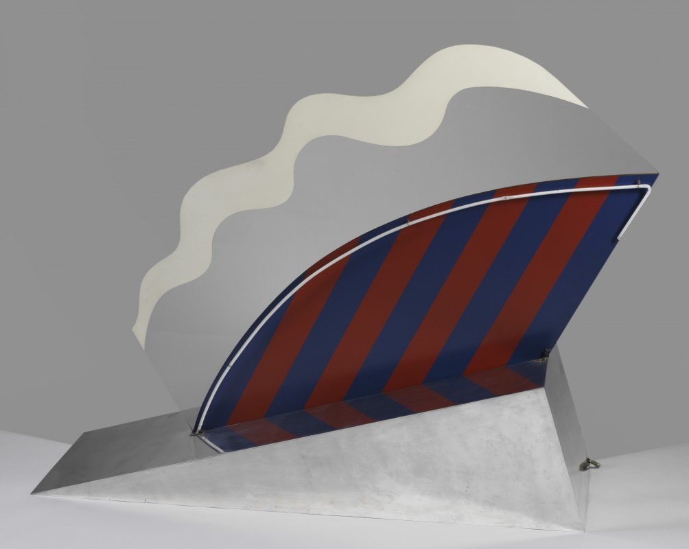 Pop-art metal sculpture of a striped sail with a wavy white cloud above it