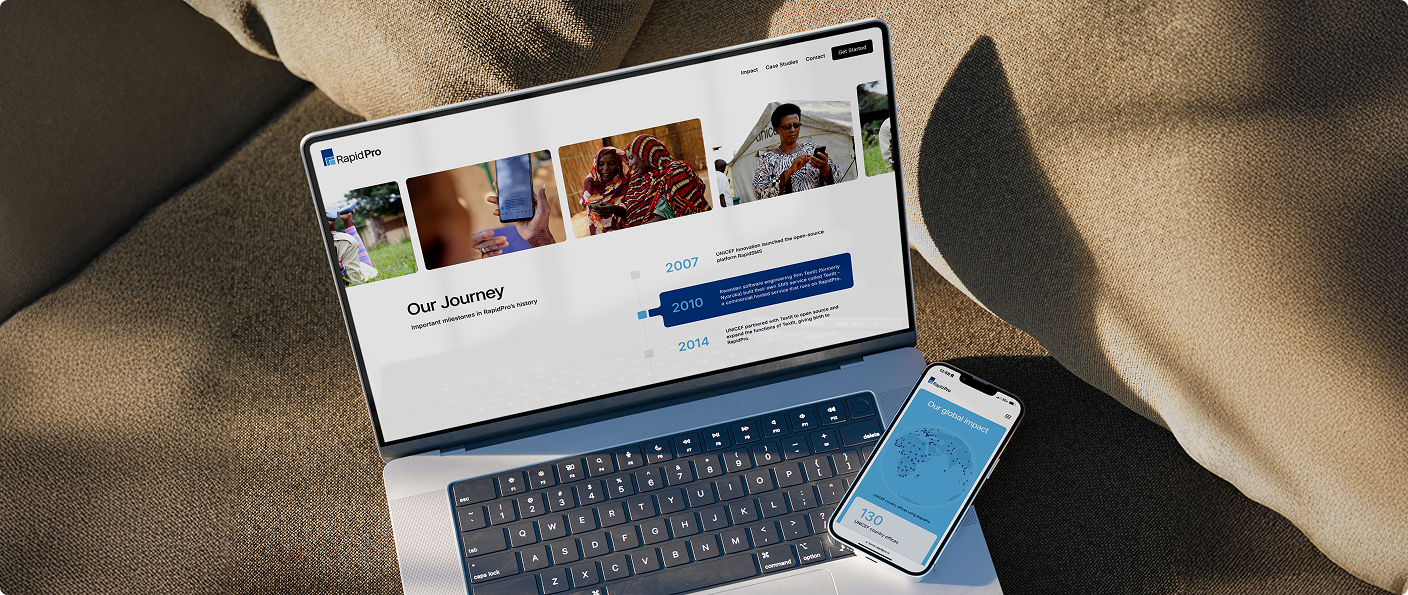Laptop and phone displaying a RapidPro website and app on textured fabric