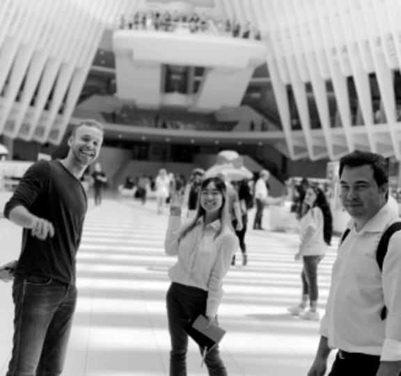 Screen Shot 2023 01 26 at 4 16 1 Black-and-white scene of three people in a bright atrium