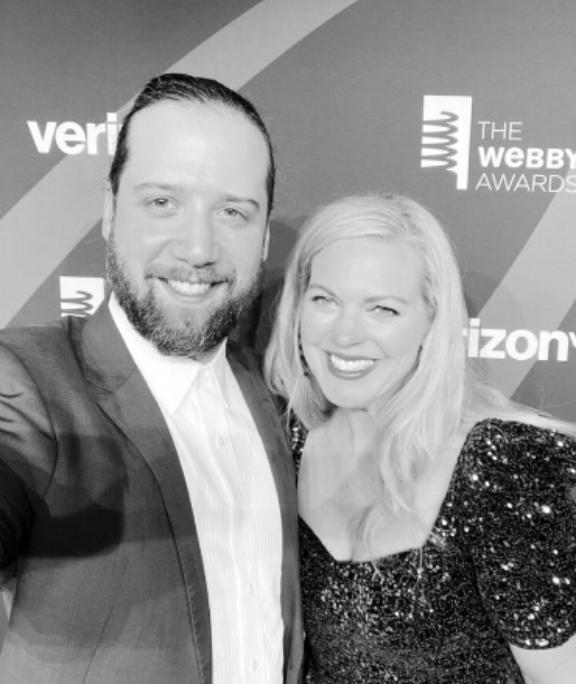 Image from i OS 12 1 Two people smiling at a Webby Awards backdrop