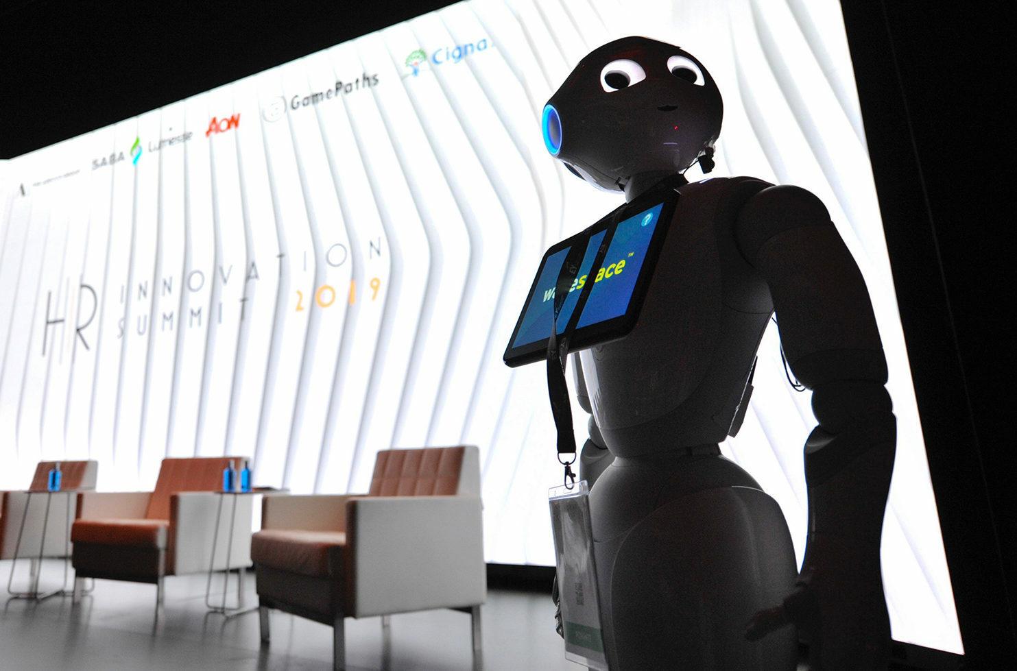 Humanoid robot standing on a stage at an HR Innovation Summit event