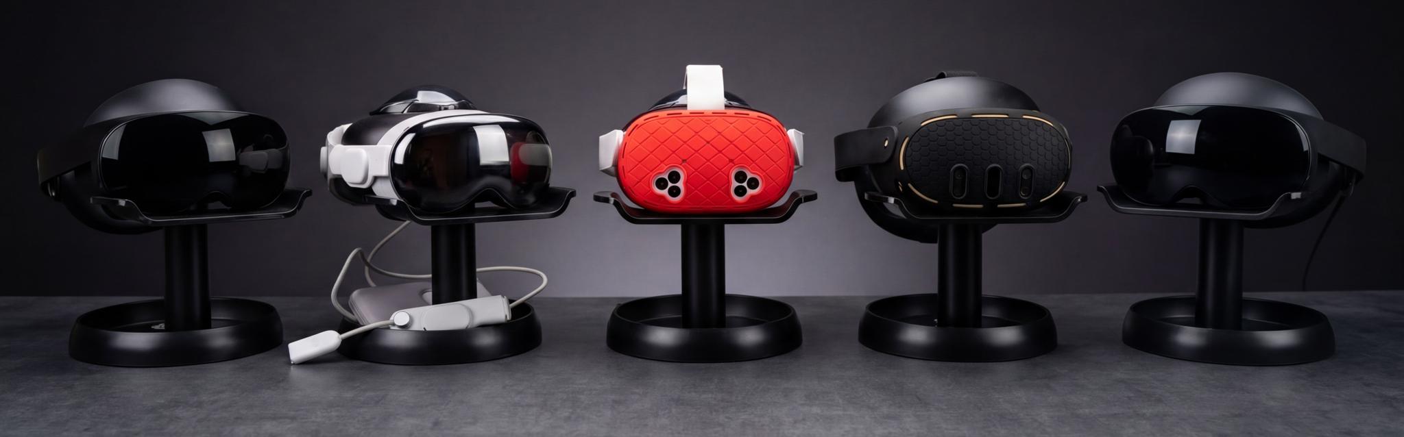 Five mixed reality headsets on black display stands, with a red headset in the center